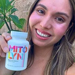 Person holding Mitolyn bottle showing weight loss supplement for metabolism support